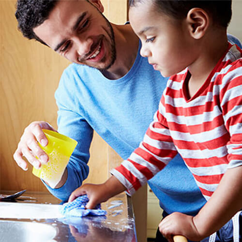 dad and toddler washing dishes