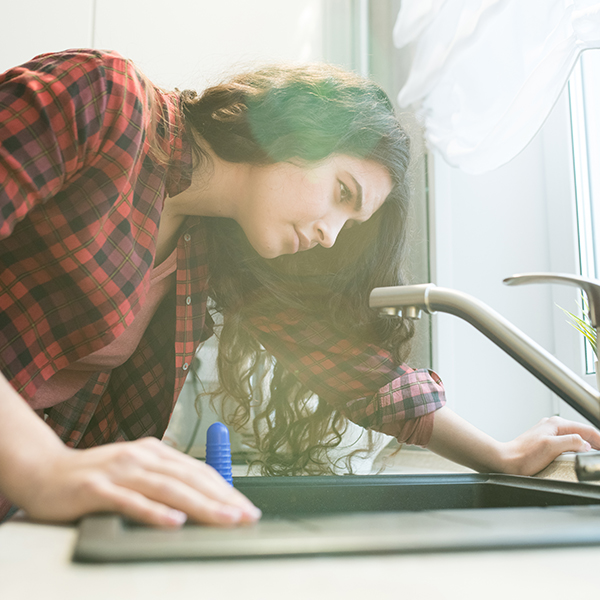 woman looking at sink with uncertainty