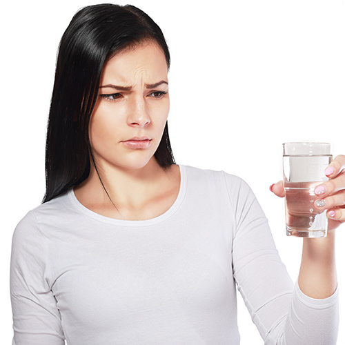 woman looking at glass of water