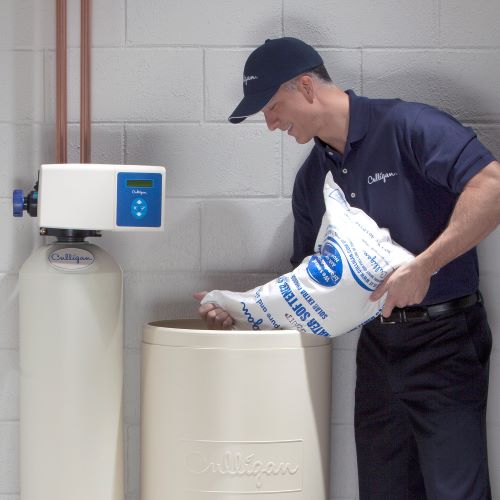 Culligan expert adding salt to water softener