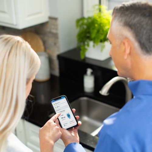looking at app from smart water filtration system